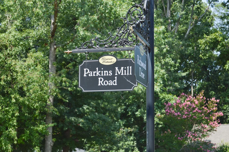 Parkins mill road sign in Greenville SC with trees in the background