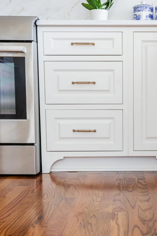 White cabinets with decorative foot details