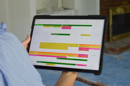 Construction process outlined on an ipad screen on a job site