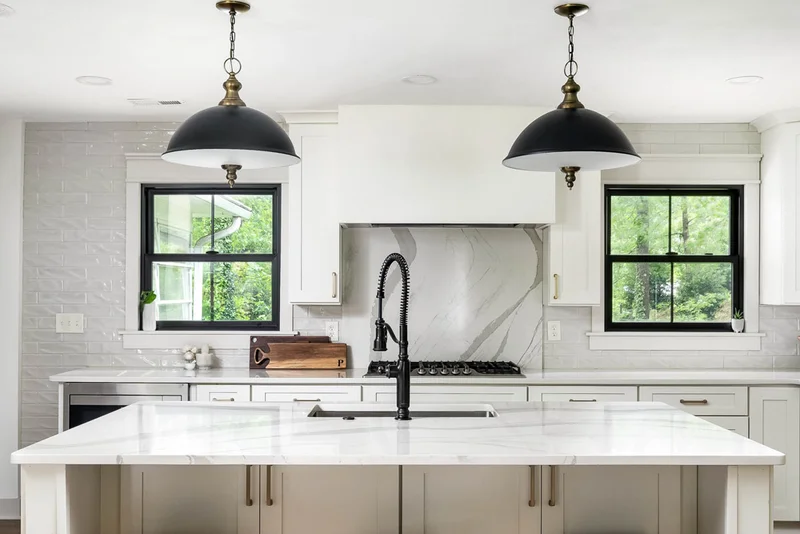 Modern white farmhouse kitchen with black accents
